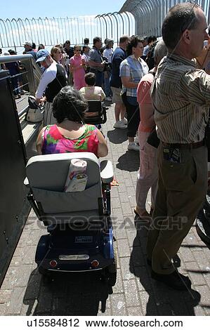 Woman with muscular dystrophy utilizing a scooter/cart to sight-see in New York City. View Large Photo Image Stock Image - Woman with muscular dystrophy utilizing a scooter/cart to sight-see in New York City.. Fotosearch