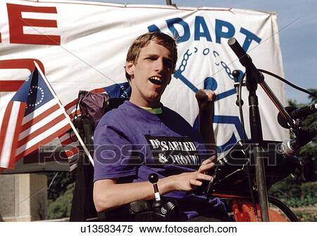 Young man with a disability who utilizes a wheelchair for mobility speaking to a crowd of people with disabilities at the ADAPT March on Washington Disability Advocacy event. View Large Photo Image Stock Photography - Young man with a disability who utilizes a wheelchair for mobility speaking to a crowd of people with disabilities at the ADAPT March on Washington Disability Advocacy event.. Fotosearch