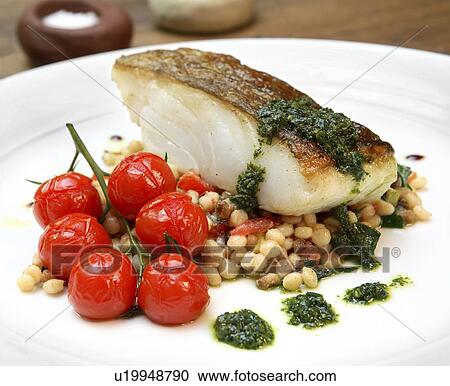 Stock Image - Cod with cherry tomatoes and pulses and salsa verde. Fotosearch