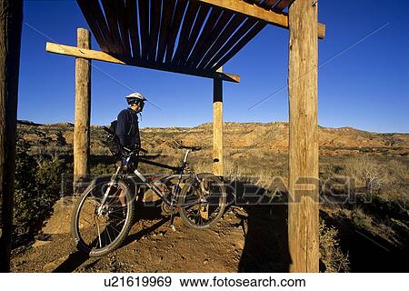 Biker takes in the view at Palo Duro Canyon View Large Photo Image Stock Photo - Biker takes in the view at Palo Duro Canyon. Fotosearch