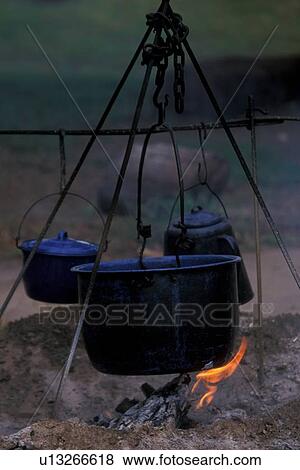 black pot of food cooking over a campfire View Large Photo Image Stock Photo - black pot of food cooking over a campfire. Fotosearch