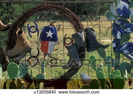 boots and other decor hanging on a fence View Large Photo Image Stock Image - boots and other decor hanging on a fence. Fotosearch