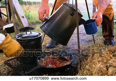close up of two people cooking at a campsite View Large Photo Image Stock Photo - close up of two people cooking at a campsite. Fotosearch