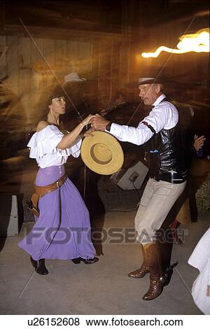 Stock Photo - Couple dances on the floor of a Western Tavern. Fotosearch