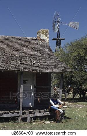 cowboy sitting on a porch with his boots View Large Photo Image Stock Image - cowboy sitting on a porch with his boots. Fotosearch