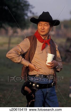 cowboy standing outside with a drink View Large Photo Image Stock Photo - cowboy standing outside with a drink. Fotosearch