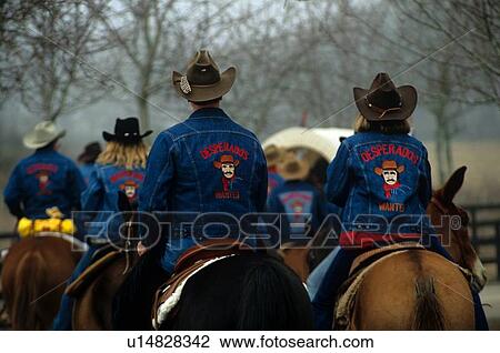 Stock Image - group riding in a line at a trail ride. Fotosearch