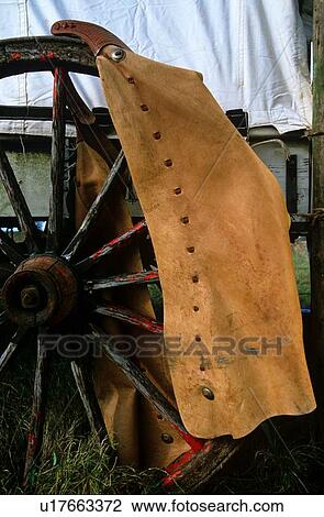 leather chaps hanging on an old wagon wheel View Large Photo Image Stock Image - leather chaps hanging on an old wagon wheel. Fotosearch