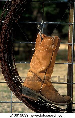 Lone cowboy boot hanging on a fence View Large Photo Image Stock Photo - Lone cowboy boot hanging on a fence. Fotosearch