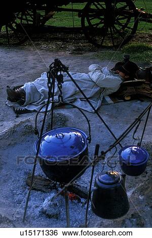 man sleeping under blankets beside the ashes of a campfire View Large Photo Image Stock Photograph - man sleeping under blankets beside the ashes of a campfire. Fotosearch