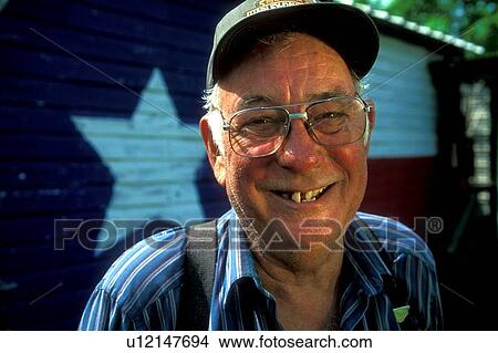 man standing in front of a wall painted with a Texas flag View Large Photo Image Picture - man standing in front of a wall painted with a Texas flag. Fotosearch