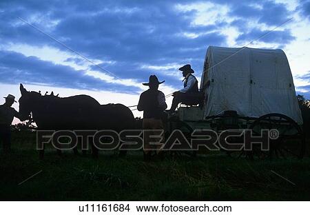 Picture - men at a western wagon on the trail ride. Fotosearch