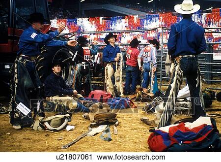 Stock Image - men organizing equipment at the Houston rodeo. Fotosearch