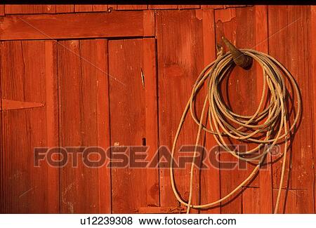 red building wall with a hanging lasso View Large Photo Image Stock Photo - red building wall with a hanging lasso. Fotosearch