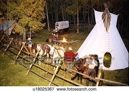 Rodeo riders in coral with teepee and chuck wagon View Large Photo Image Stock Photo - Rodeo riders in coral with teepee and chuck wagon. Fotosearch