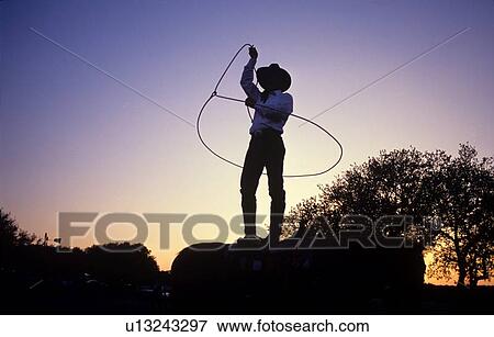 silhouette of a cowboy swinging his lasso View Large Photo Image Stock Photo - silhouette of a cowboy swinging his lasso. Fotosearch