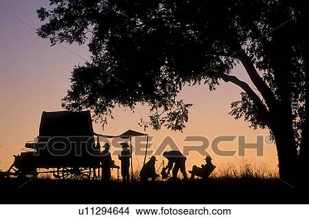 silhouette of a group cooking at the back of a wagon View Large Photo Image Picture - silhouette of a group cooking at the back of a wagon. Fotosearch