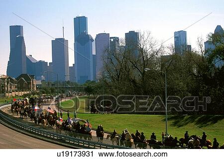 Stock Image - trail ride to the rodeo with the downtown skyline. Fotosearch