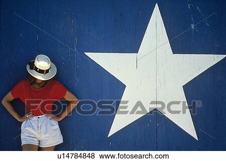 woman standing in front of a blue wall View Large Photo Image Stock Photo - woman standing in front of a blue wall. Fotosearch