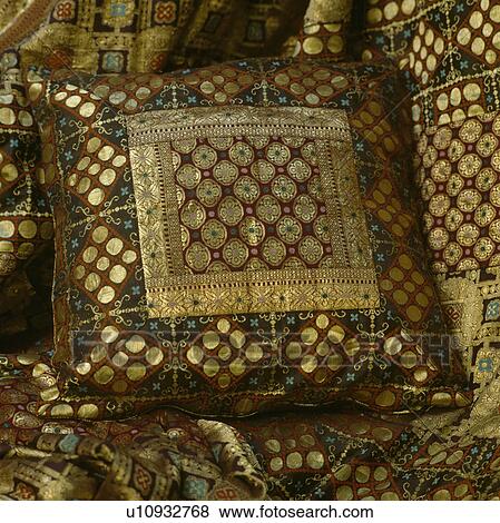 Stock Photo - Abstract patterned fabric with gilt thread used for a cushion.. Fotosearch