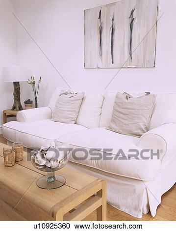 Abstract picture above white sofa with loosecover and grey cushions in modern white living room View Large Photo Image Stock Image - Abstract picture above white sofa with loosecover and grey cushions in modern white living room. Fotosearch