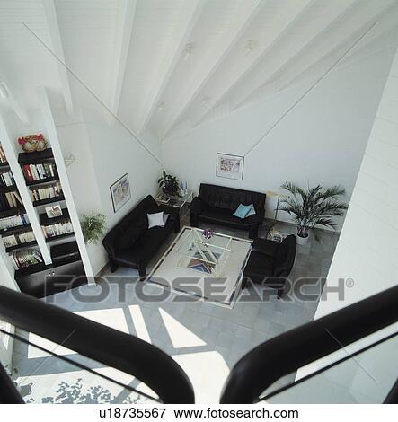 Aerial view of black sofas in modern white living room View Large Photo Image Stock Photo - Aerial view of black sofas in modern white living room. Fotosearch
