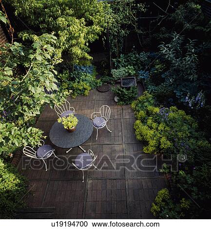 Aerial view of table and chairs on patio in large town garden in summer View Large Photo Image Stock Image - Aerial view of table and chairs on patio in large town garden in summer . Fotosearch