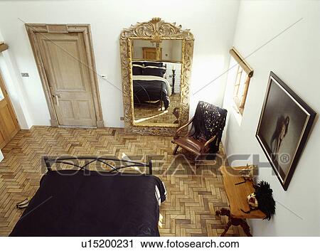 Aerial view of white bedroom with large gilt mirror on parquet floor View Large Photo Image Stock Image - Aerial view of white bedroom with large gilt mirror on parquet floor . Fotosearch