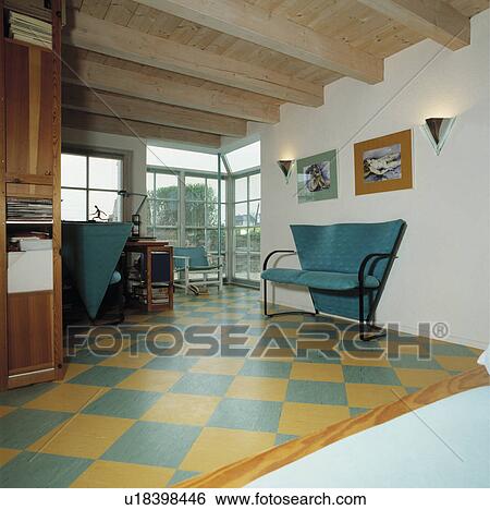 Angular turquoise sofa in modern hall living room with wooden ceiling and yellow+turquoise chequerboard floor View Large Photo Image Stock Photograph - Angular turquoise sofa in modern hall living room with wooden ceiling and yellow+turquoise chequerboard floor. Fotosearch