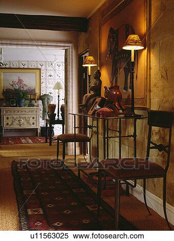 Antique chairs and modern console table in country hall lit by wall lights View Large Photo Image Stock Photography - Antique chairs and modern console table in country hall lit by wall lights. Fotosearch