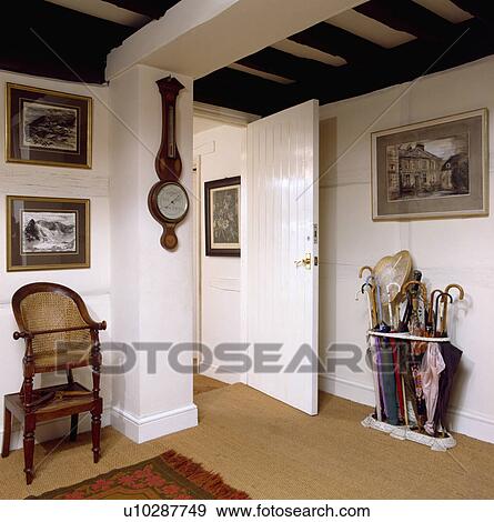 Antique childs highchair and barometer in white cottage hall with beamed ceiling and sisal carpet View Large Photo Image Stock Photo - Antique childs highchair and barometer in white cottage hall with beamed ceiling and sisal carpet. Fotosearch
