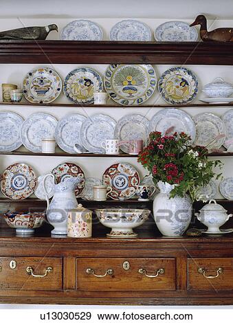 Stock Photo - Antique plates on shelves of antique oak kitchen dresser. Fotosearch