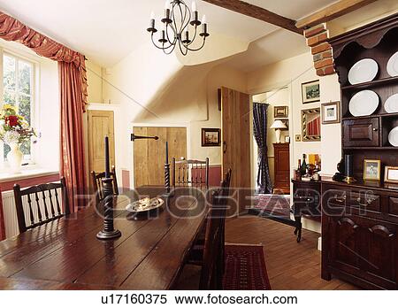 Stock Photography - Antique rectangular wooden table and chairs in country diningroom with wooden floor. Fotosearch