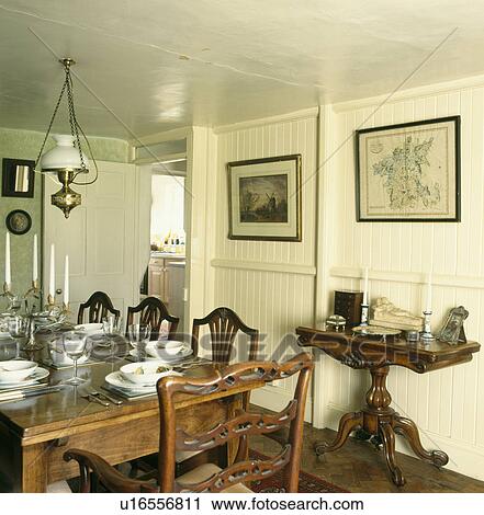 Antique table and chairs in neutral dining room with panelled cream walls View Large Photo Image Stock Image - Antique table and chairs in neutral dining room with panelled cream walls. Fotosearch