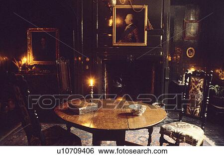 Stock Photograph - Antique table and chairs in panelled Jacobean townhouse dining room. Fotosearch