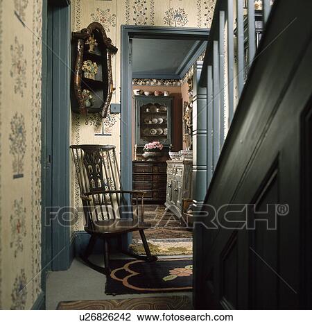 Antique wooden chair and blue paintwork in traditional hall with Shaker-inspired wallpaper View Large Photo Image Stock Image - Antique wooden chair and blue paintwork in traditional hall with Shaker-inspired wallpaper. Fotosearch