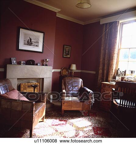 Armchair beside fireplace in traditional red living room View Large Photo Image Stock Photo - Armchair beside fireplace in traditional red living room. Fotosearch