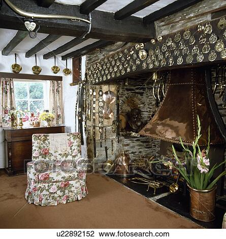 Armchair Beside Inglenook Fireplace In Traditional Cottage Living