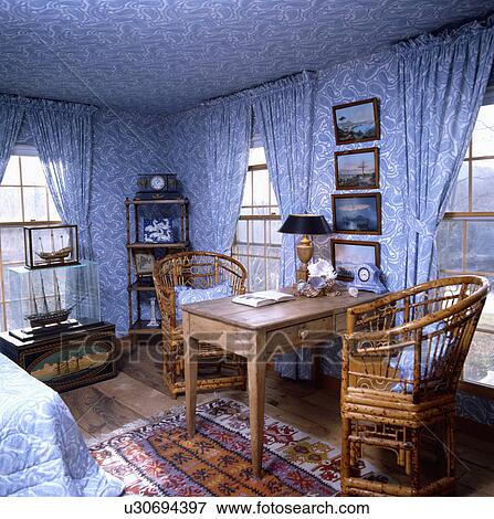 Bamboo chairs and old pine table in bedroom with blue+white Paisley wallpaper and matching curtains on windows View Large Photo Image Stock Photo - Bamboo chairs and old pine table in bedroom with blue+white Paisley wallpaper and matching curtains on windows. Fotosearch
