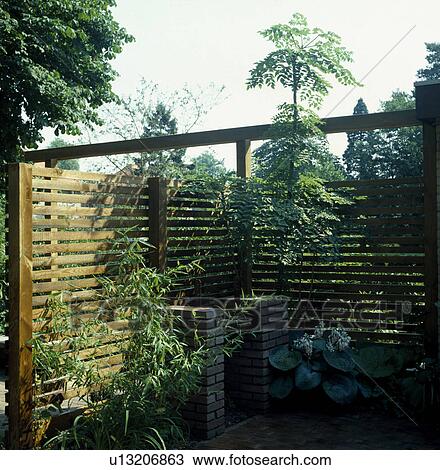 Barbeque enclosed by wooden fence in country garden View Large Photo Image Stock Image - Barbeque enclosed by wooden fence in country garden. Fotosearch