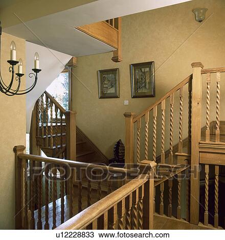 Stock Image - barleytwist wooden bannisters on staircase on neutral landing. Fotosearch