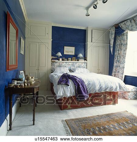 Bed In Alcove Between Fitted Wardrobes In Traditional Bedroom With