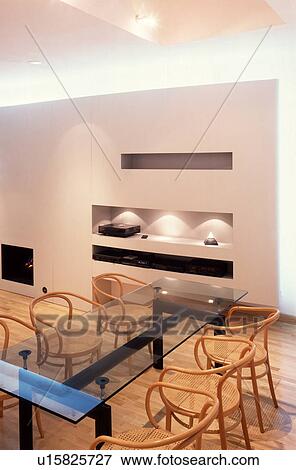 Stock Photo - Bentwood chairs and glass table in modern white dining room with alcove lighting. Fotosearch