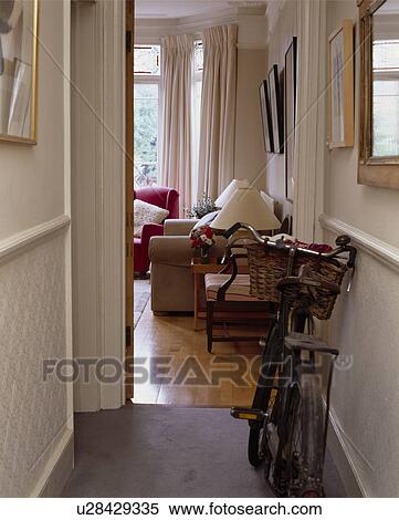 Stock Photography - Bicycle in small traditional hall with open door and view of living room. Fotosearch