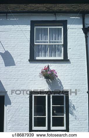 Stock Photo - Black and white casement and sash windows on white cottage. Fotosearch