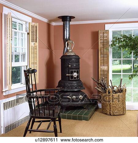 Black stove and antique chair in terracotta country living room View Large Photo Image Stock Image - Black stove and antique chair in terracotta country living room. Fotosearch