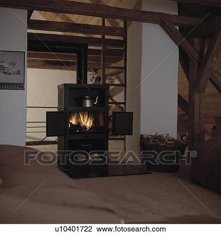 Black stove in centre of loft bedroom View Large Photo Image Stock Image - Black stove in centre of loft bedroom. Fotosearch