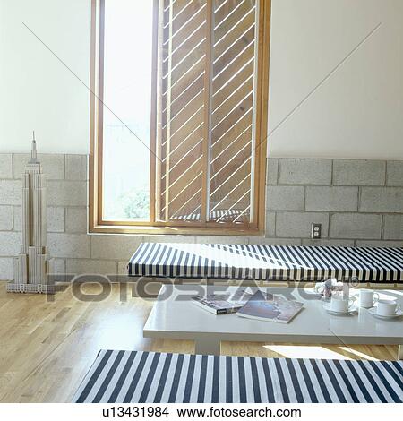 Picture - Blue and white striped daybeds in front of window in modern Californian living room. Fotosearch