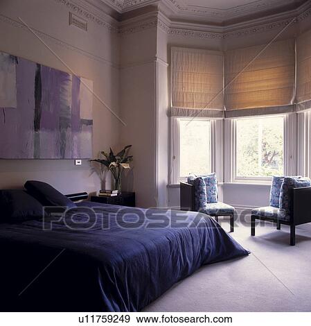 Stock Photo - Blue and white traditional bedroom with cornice, picture rail and bay window. Fotosearch
