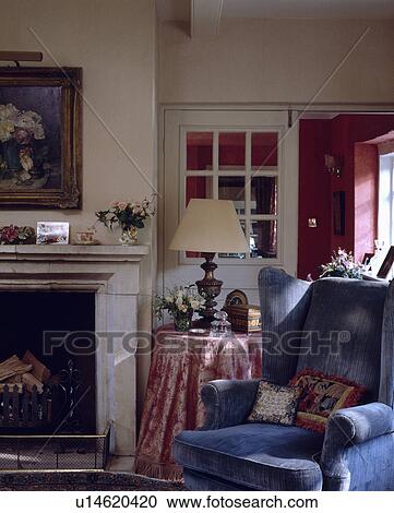 Blue armchair beside fireplace in traditional living room View Large Photo Image Stock Image - Blue armchair beside fireplace in traditional living room. Fotosearch